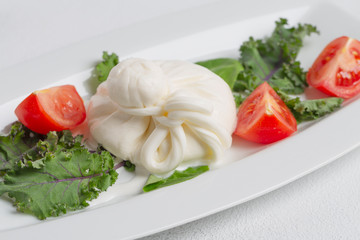 Fresh Italian buratta cheese with tomatoes.