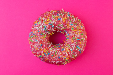 Delicious sweet donut. Top view. Bright and colorful sprinkled donut close-up macro shot
