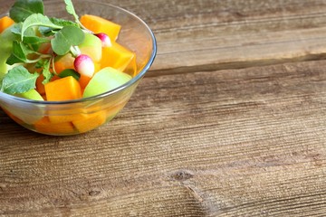 Fermented salad from butternut and green apple with dressing. Vegetarian fermented salad decorated with young radish, copy space