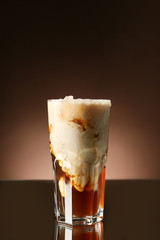 Glass with iced coffee on dark background