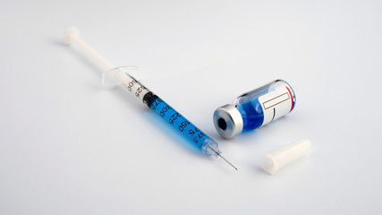 Close-up of a syringe and a vial of injectable solution
