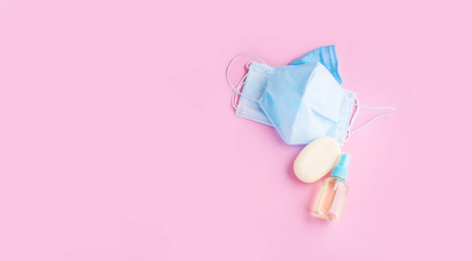 Blue face mask with soap and hand antiseptic on a light background. Protection from the virus.