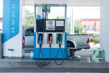 Gas stations filling cars for cars during times of economic downturn and oil prices dropped...