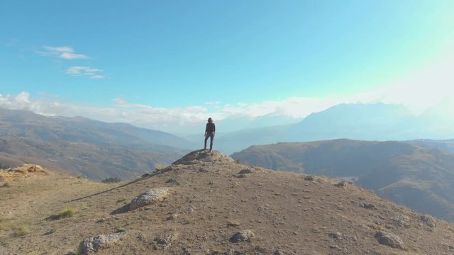 Sunrise, wake up in the peruvian andes, amazing view to the mountains, traveler female model alone in front center of the frame