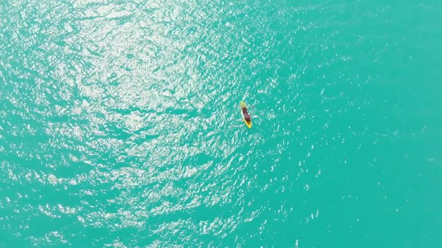 couple in kayak in tje center of paron lake, peruvian andes, cenital view goin down, aerial shot,