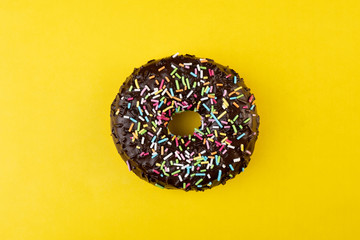 Candy chocolate on frosted doughnut.