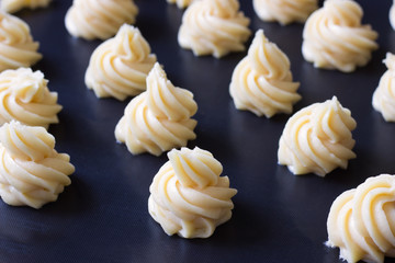 Profiteroles  cooking , dough on a baking mat