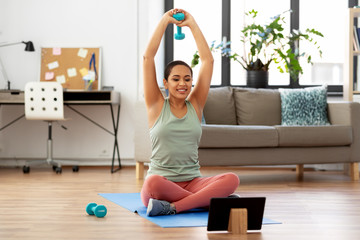 fitness, sport and healthy lifestyle concept - happy smiling african american woman with tablet pc...