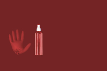 A medical glove and a a bottle of transparent sanitizer with outer place