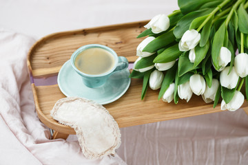 Romantic morning.A coffee table in a pink bed, a Cup of coffee and flowers on the table. Valentine's day