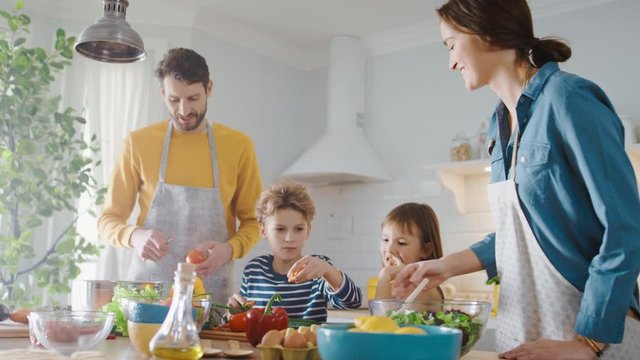 In Kitchen: Family of Four Cooking Together Healthy Dinner