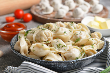Plate with tasty dumplings on table