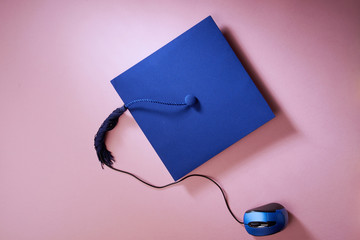 The graduation cap and computer mouse mouse