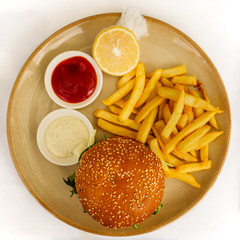 Flat lay of a burger and chips / French fries