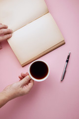 top view of man holding blank book