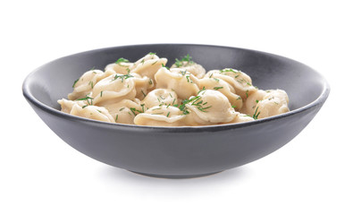 Bowl with tasty dumplings on white background