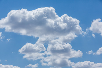Blue sky with white curly clouds