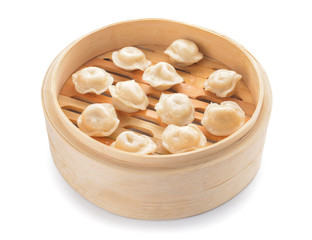 Steamer with tasty dumplings on white background