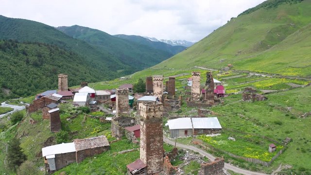 Ancient stone towers and Ushguli village at the foot of Mt. Shkhara. Picturesque and gorgeous scene. Rock tower towers and old houses in Ushguli.