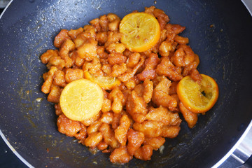 Chicken meat cut into small pieces and wrapped in egg flour mixture. Put into the hot pan. It is fried using hot cooking oil until cooked and crunchy. Added with orange as a seasoning.