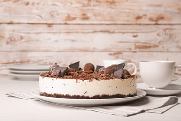 Tasty chocolate cheesecake on table
