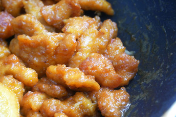 Chicken meat cut into small pieces and wrapped in egg flour mixture. Put into the hot pan. It is fried using hot cooking oil until cooked and crunchy. Added with orange as a seasoning.