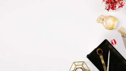 Fototapeta na wymiar Blogging concept. Stylish feminine workplace with luxury golden lipstick, clips, watch, parfume, envelopes and black leather notebook. Elegant modern template for feminine identity. Flat lay, overhead