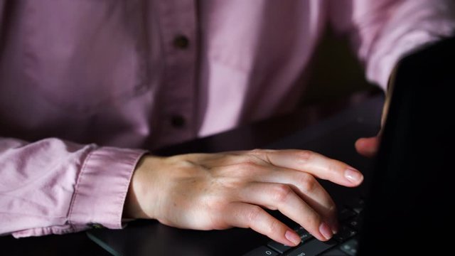 Female hands counting dollar bills in envelope