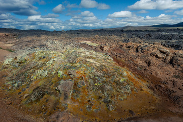 Beautiful colourful Icelandic landscape lava fields mountain geysers zigzag road and moss-covered...