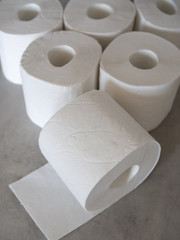 White toilet paper on grey background.