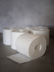 White toilet paper on grey background.