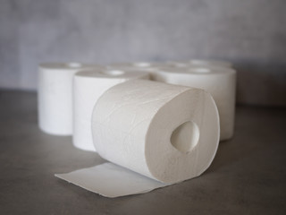 White toilet paper on grey background.