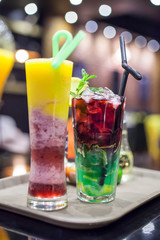 Colorful glasses of smoothie and mojito