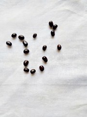 Black pulse grains on a white cotton background