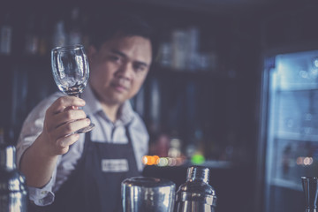 Bartenders mix drinks and serve them to customers