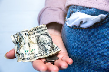 One dollar and petty cash only, empty pocket. No money. Economy crisis, poverty, unemployment concept. Consequences of coronavirus people isolation during quarantine. Inflation rates. Price growth. .