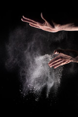 Obraz na płótnie Canvas Flour Explosion in mans hand