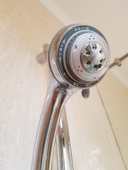 Closeup of stainless steel shower head in bathroom.
Housewares concept.
