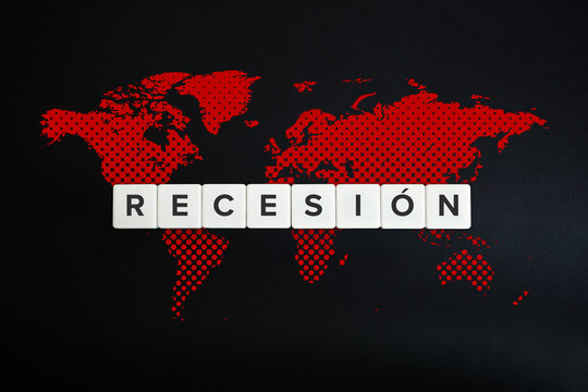 World recession (recesion) and global crisis caused by coronavirus. Spanish text and textured red world map on black background.