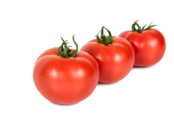 Three red tomatoes on a white background