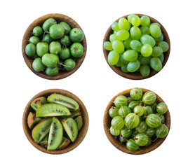 Green food isolated on a white background. Collage of different fruits and berries at green color.Green baby kiwi fruit actinidia, kiwi; gooseberry and green grapes in a wooden bowl. Fruit and berry