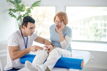 Fototapeta premium Red haired aged woman screaming from pain