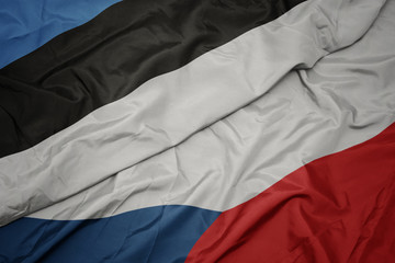 waving colorful flag of czech republic and national flag of estonia.