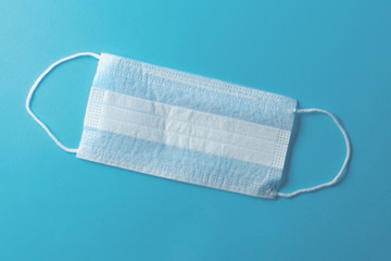 White medical mask on a blue background