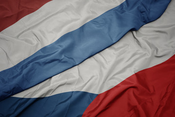 waving colorful flag of czech republic and national flag of luxembourg.