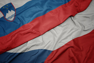 waving colorful flag of czech republic and national flag of slovenia.