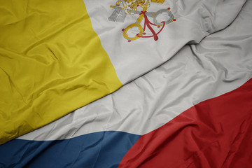 waving colorful flag of czech republic and national flag of vatican city.