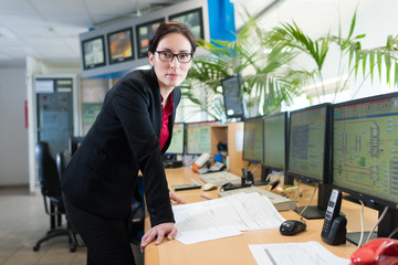 businesswoman in office with tv screens