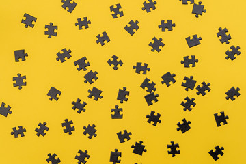Black puzzles on a yellow background. Minimalism