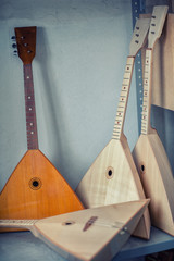 Ready-made balalaika in a musical instrument warehouse - obrazy, fototapety, plakaty